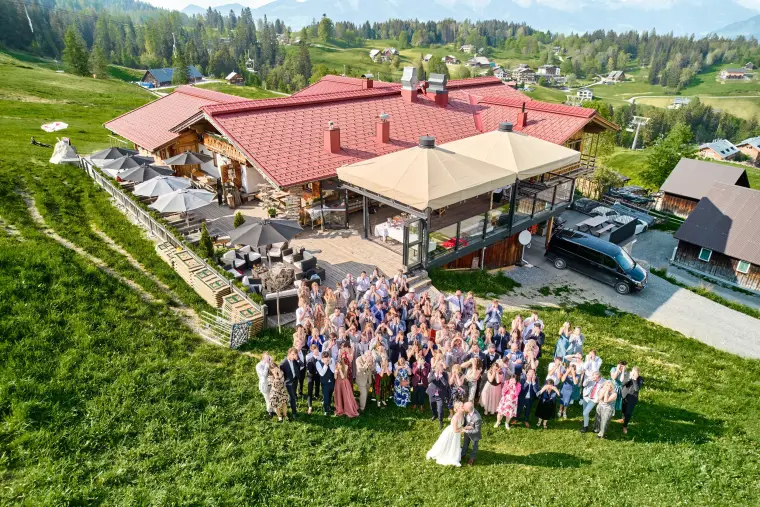 Hochzeitsreportage: Hochzeitsgesellschaft vor Berghütte